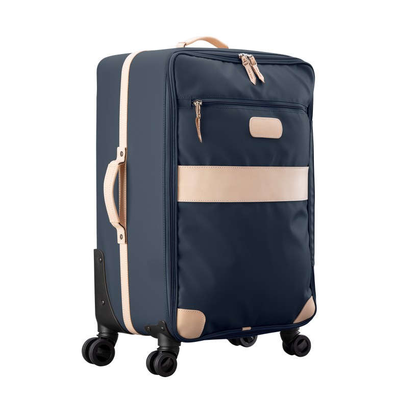 Large 360 wheeled luggage diagonal view in Color 'Navy Coated Canvas'